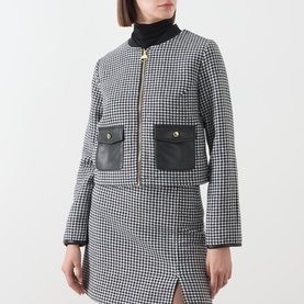 Model wearing Barbour International Halina Gingham Zip Jacket in black and white houndstooth with black leather-look patch pockets, styled with