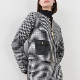 Model wearing Barbour International Halina Gingham Zip Jacket in black and white gingham, cropped length, leather-look front pocket, gold zip, with