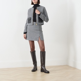 Model wearing Barbour International Halina Gingham Zip Jacket in Multi, styled with a mini skirt and dark knee-high boots