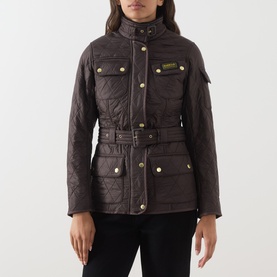 Model wearing Barbour International truffle quilted jacket with belted waist, snap button fastenings, and gold-tone hardware.