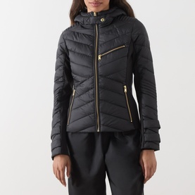 Model wearing Barbour International Salengro Quilted Jacket in black with gold-toned zips, adjustable hood, and stretch side panels, styled with