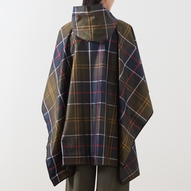 Model wearing Barbour poncho in multi tartan check, rear view, with hood up, styled over olive trousers