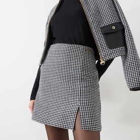 Model wearing Barbour International Halina Gingham Mini Skirt in black and white check with front split, styled with matching gingham jacket and