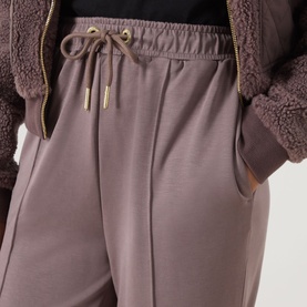 Model wearing Barbour International Truffle trousers with elasticated drawstring waist and side pockets, styled with a teddy fleece jacket.