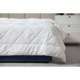 Belledorm Microfibre Ultra Light Duvet 1.5 Tog in white, diamond-quilted finish, styled on a bed with navy base.