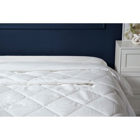 Belledorm Microfibre Ultra Light Duvet 1.5 Tog in white, diamond-quilted pattern, shown on a made bed with navy headboard.