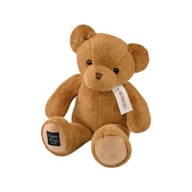 Dou Dou brown plush teddy bear with cream paw pads, black bead eyes, and branded label ribbon, seated upright