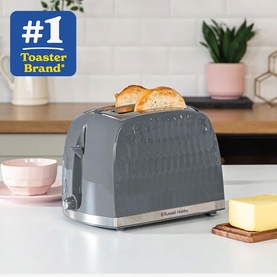 Russell Hobbs Honeycomb 2 Slice Toaster in grey with textured body and chrome accents, toasting bread on a kitchen counter