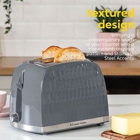 Russell Hobbs Honeycomb 2 Slice Toaster in grey with embossed honeycomb pattern, stainless steel accents, and two toast slices visible