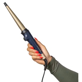 Hand holding a navy and gold tapered curling wand with a pointed barrel, shown against a white background