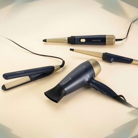 Remington Sapphire Luxe Hair Dryer in Deep Navy and Champagne, shown alongside matching hair straightener, curling wand, and tong styling tools