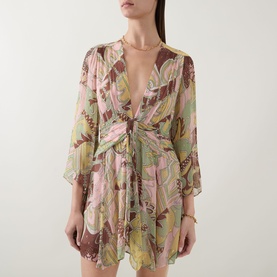 Model wearing Rixo Clove Bianca Abstract Mini Dress in Bianca Abstract Green with plunge neckline, draped empire waist and three-quarter sleeves