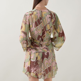Model wearing Rixo Clove Bianca Abstract Mini Dress in Bianca Abstract Green, rear view showing three-quarter sleeves and draped empire waist detail.