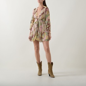 Model wearing Rixo Clove Bianca Abstract Mini Dress in Bianca Abstract Green with tan cowboy boots