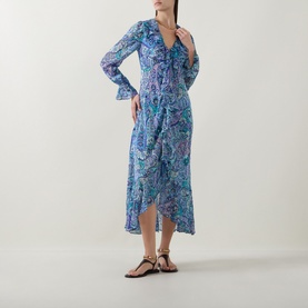 Model wearing Rixo dress in Bianca Abstract Blue, blue paisley silk midi length with long flared sleeves and wrap-style skirt, styled with gold