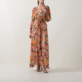 Model wearing Rixo Chelsea Floral Black maxi dress with deep V-neck, long sleeves, wrap front, and floral print, styled with black strappy heels.