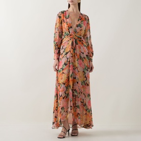 Model wearing Rixo Chelsea Floral Black maxi dress with V-neckline, long sleeves, twisted waist detail and flowy skirt.