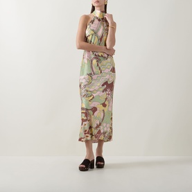 Model wearing Rixo Maura Bianca Abstract Dress in Bianca Abstract Green, halter neck midi length, styled with dark platform mules.