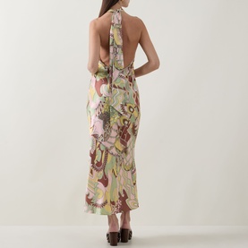 Model wearing Rixo Maura Bianca Abstract Dress in Bianca Abstract Green, showing low open back, halter neckline, and midi length.