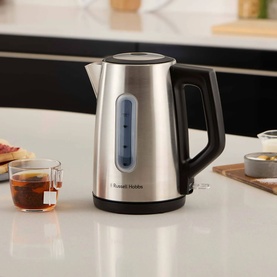 Russell Hobbs Classics Illuminated Kettle in silver stainless steel with blue window gauge, black handle, on kitchen counter with tea cups