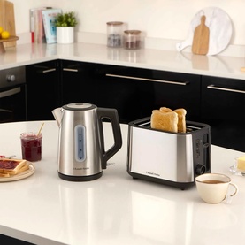 Russell Hobbs Classics Illuminated Kettle in silver, styled with matching toaster on white kitchen counter, toast and teacup visible