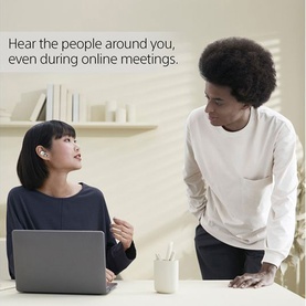 Two people at a desk during an online meeting, one wearing Sony Linkbuds True Wireless Earbuds White, with a laptop open in front of them.