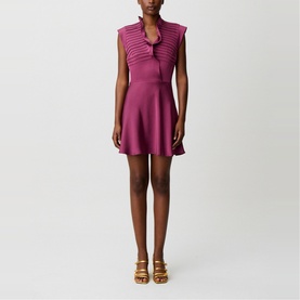 Model wearing Claude Pierlot purple sleeveless mini dress with V-neck and ribbed detail, styled with tan heeled sandals.