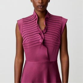 Model wearing Claude Pierlot purple dress with pleated ruffle neckline and sleeveless fit-and-flare silhouette