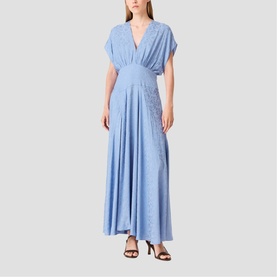 Model wearing a blue V-neck short-sleeve maxi dress with flared skirt, styled with black strappy heels