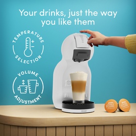 Delonghi Mini Me 2 Iced Creations Bundle in white, shown with a hand inserting a pod, latte in cup, coffee capsules alongside