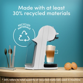 Delonghi Mini Me 2 Iced Creations Bundle in white with recycled materials badge, shown with coffee capsules and a latte on a wooden surface.