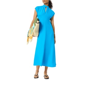 Model wearing Whistles blue midi dress with keyhole neckline and cap sleeves, styled with tan tote bag and flip flops