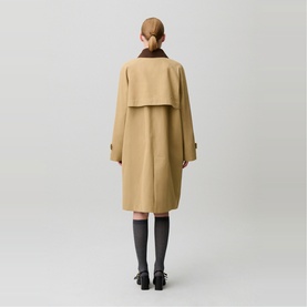 Model wearing Claude Pierlot Womens French Dress in clear beige, rear view, with dark grey ribbed socks and black loafers
