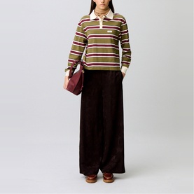 Model wearing Claude Pierlot dark brown wide-leg corduroy trousers, styled with striped rugby top and burgundy shoulder bag.