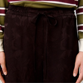 Model wearing Claude Pierlot dark brown jacquard drawstring skirt with elasticated waist, styled with striped top