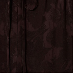 Claude Pierlot dark brown womenswear dress in tonal floral jacquard fabric, close-up detail shot showing textured pattern and tie fastening