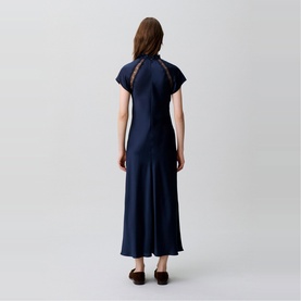Model wearing Claude Pierlot Womens French Dress in blue, shown from behind, featuring cap sleeves, lace back detail, and midi length flared hem.