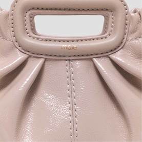 Maje mastic beige patent leather mini bag with structured top handle, ruched detail, and gold-tone logo lettering
