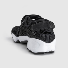 Black mesh split-toe sandal trainer with velcro strap, chunky white sole, rear view