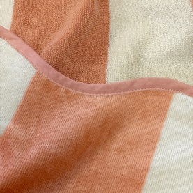 Allure Scallop Beach Towel in orange and cream, 100% cotton jacquard weave with pink scallop-edged trim detail, close-up texture shot.