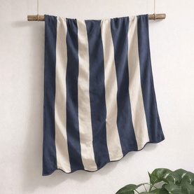 Allure Scallop Beach Towel Navy, 100% cotton with bold navy and cream vertical stripes, hung from a wooden rod