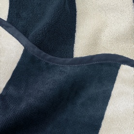 Allure Scallop Beach Towel Navy, 100% cotton, close-up showing navy and cream striped jacquard texture with scalloped edge detail.