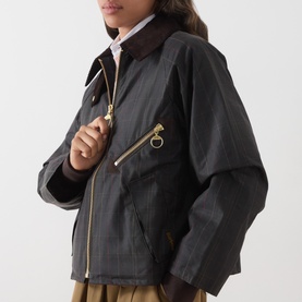 Model wearing Barbour waxed cotton jacket in Classic Shadow, featuring gold-tone zip, ring pull detail, and brown corduroy collar