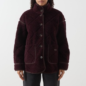 Model wearing Barbour Maplewood Fleece Jacket in Fig/Ganache, quilted borg with stand collar, button fastenings and slip pockets