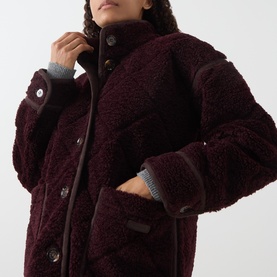 Model wearing Barbour Maplewood Fleece Jacket in Fig/Ganache, showing stand-up collar, button fastenings, and contrast trim detail.