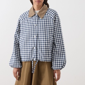 Model wearing Barbour gingham navy and neutral jacket with contrast tan collar, cropped fit, balloon sleeves, and drawstring hem, styled with khaki