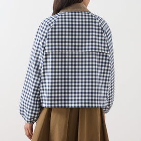 Model wearing Barbour gingham navy jacket, rear view, shown with khaki wide-leg skirt. Check print with neutral collar detail.