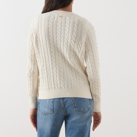 Model wearing Barbour Ashdown Cable-Knit Sweater in ecru, showing cable-knit back detail and embroidered logo, styled with blue jeans.