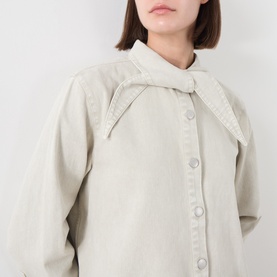 Model wearing Barbour Harleigh Tie-Neck Denim Shirt in Washed Birch, showing elongated collar and front button fastening.