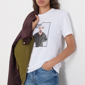 Model wearing Barbour Mariana Dog T-Shirt in white with dog photo print, styled with blue jeans and burgundy coat.
